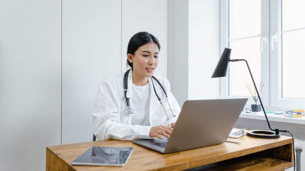 Women doctor undertaking teleradiology.